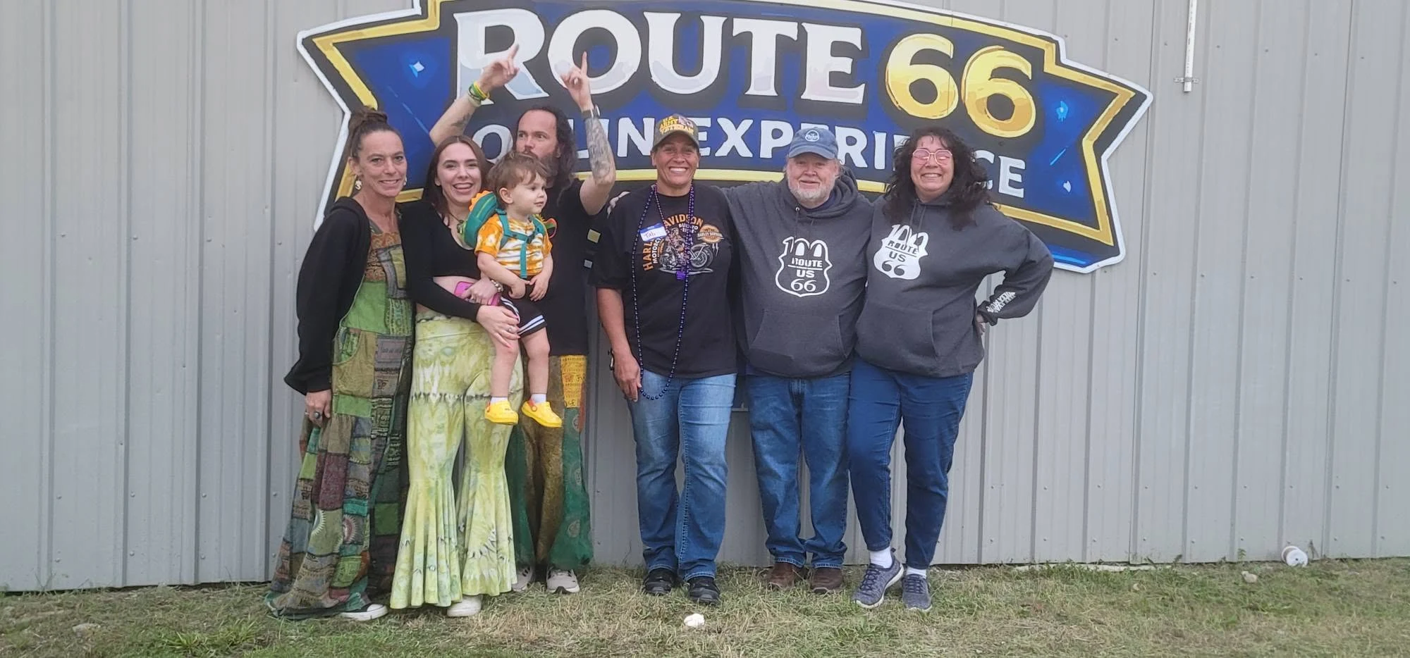 A group gathered beside the Route 66 Joplin Experience sign